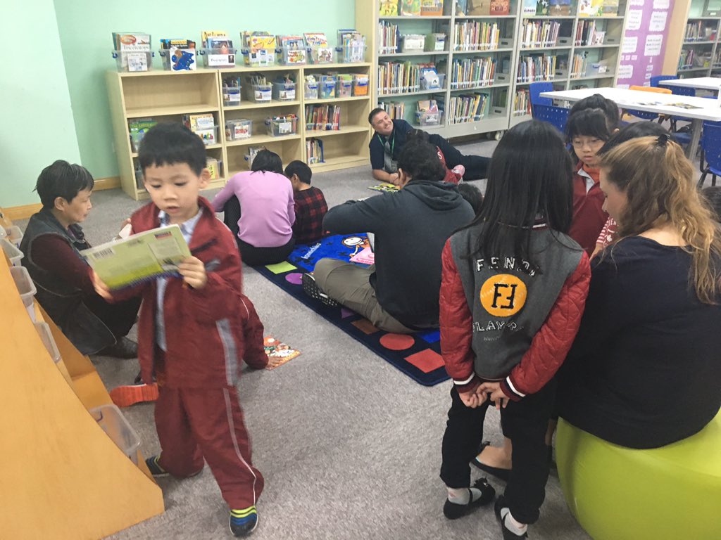 GinaAwalt's tweet photo. Family Read in kindergarten this morning. Parents and students enjoying our #ISNSLibrary #ISNSReads #GoISNS #literacy https://t.co/b25qgGpJQi