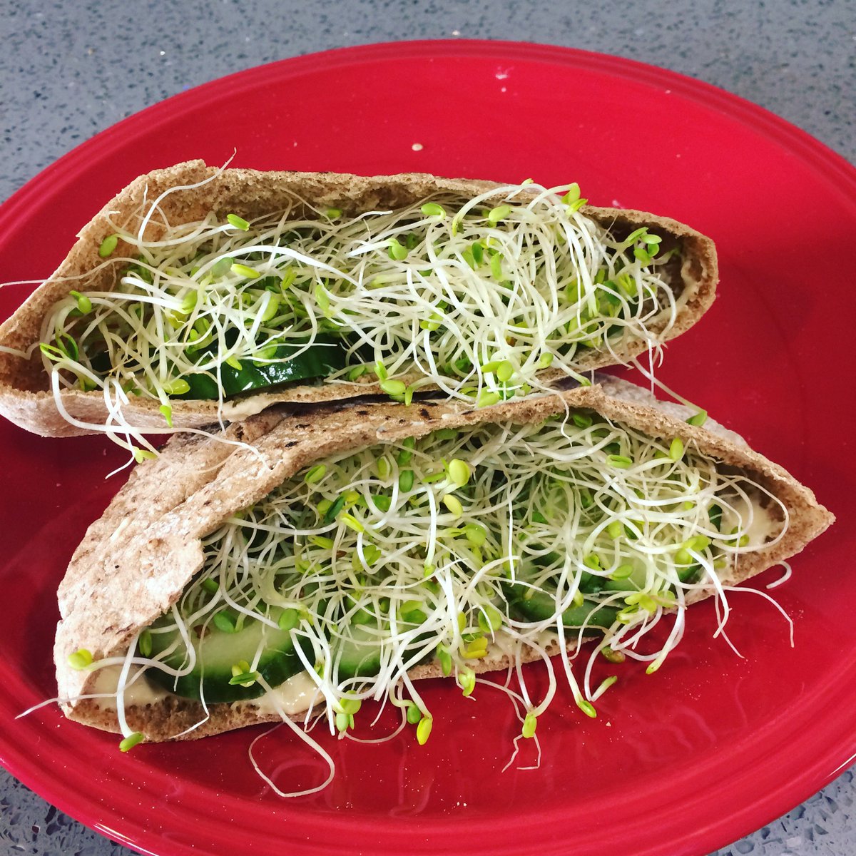 Quick and easy #lunch before hopping on more client phone calls. Warm pitas (100% whole wheat) with hummus, sliced cucumbers, and sprouts