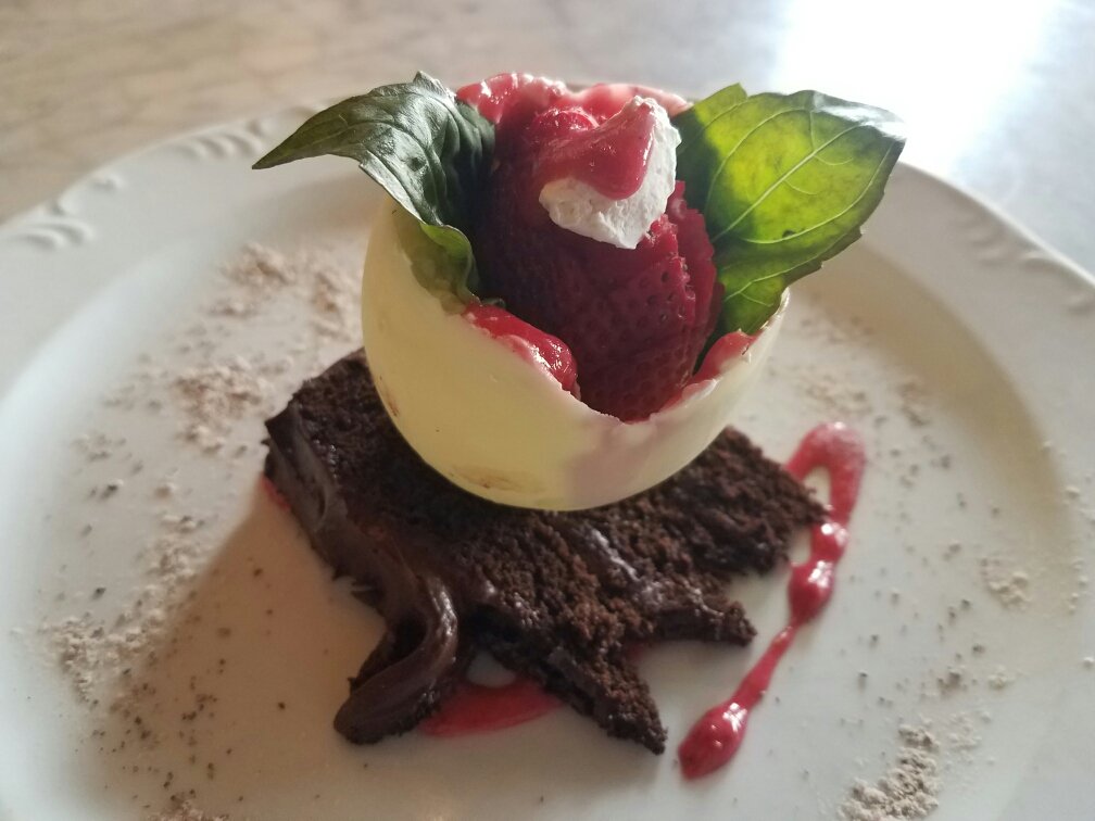 We are ready for dessert. Chocolate cake topped with a white chocolate strawberry. Seating still available for V-Day.