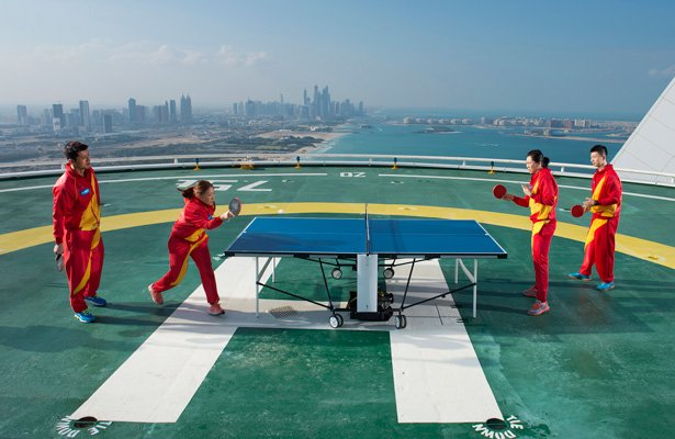 usatabletennis's tweet photo. The Chinese National Team play on a helipad at Burj El-Arab in Dubai! Where's a cool place to play @USABadminton? #locationgames https://t.co/BfRaO0bmIM