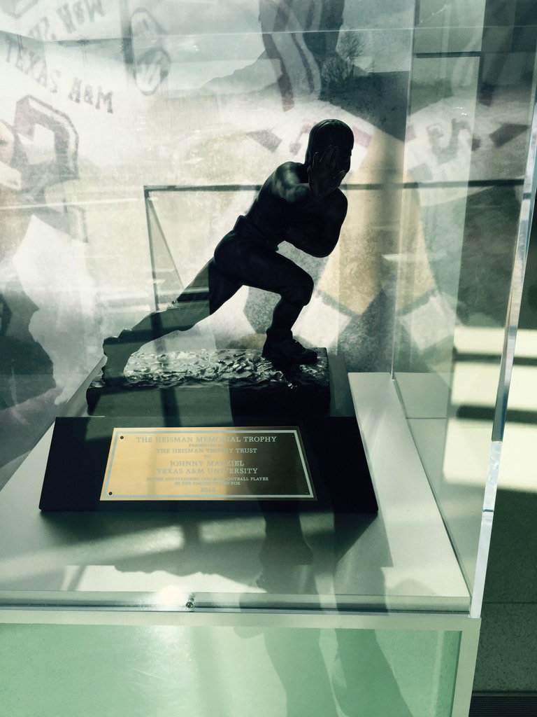 RO coaches checking out the Manziel Heisman while talking to A&amp;M coaches. #GoHawks #BirdGang