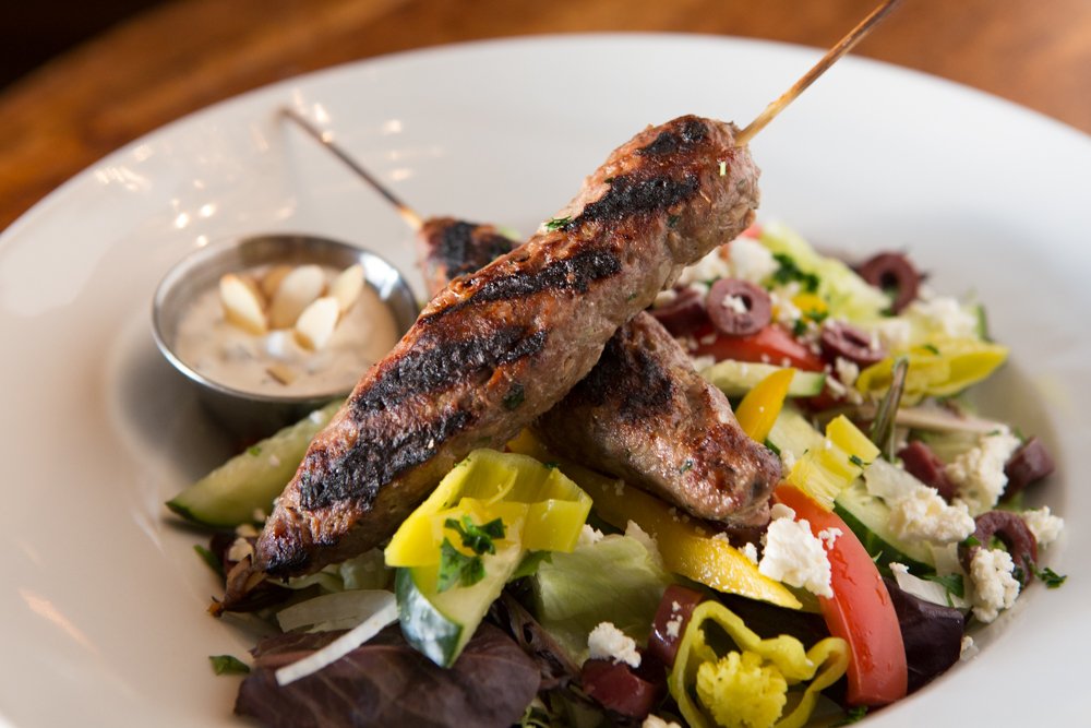 How do you make a good Greek salad better? By criss-crossing it with a pair of kofta-style lamb kebabs, of course. clydesprimerib.com/greek-salad/