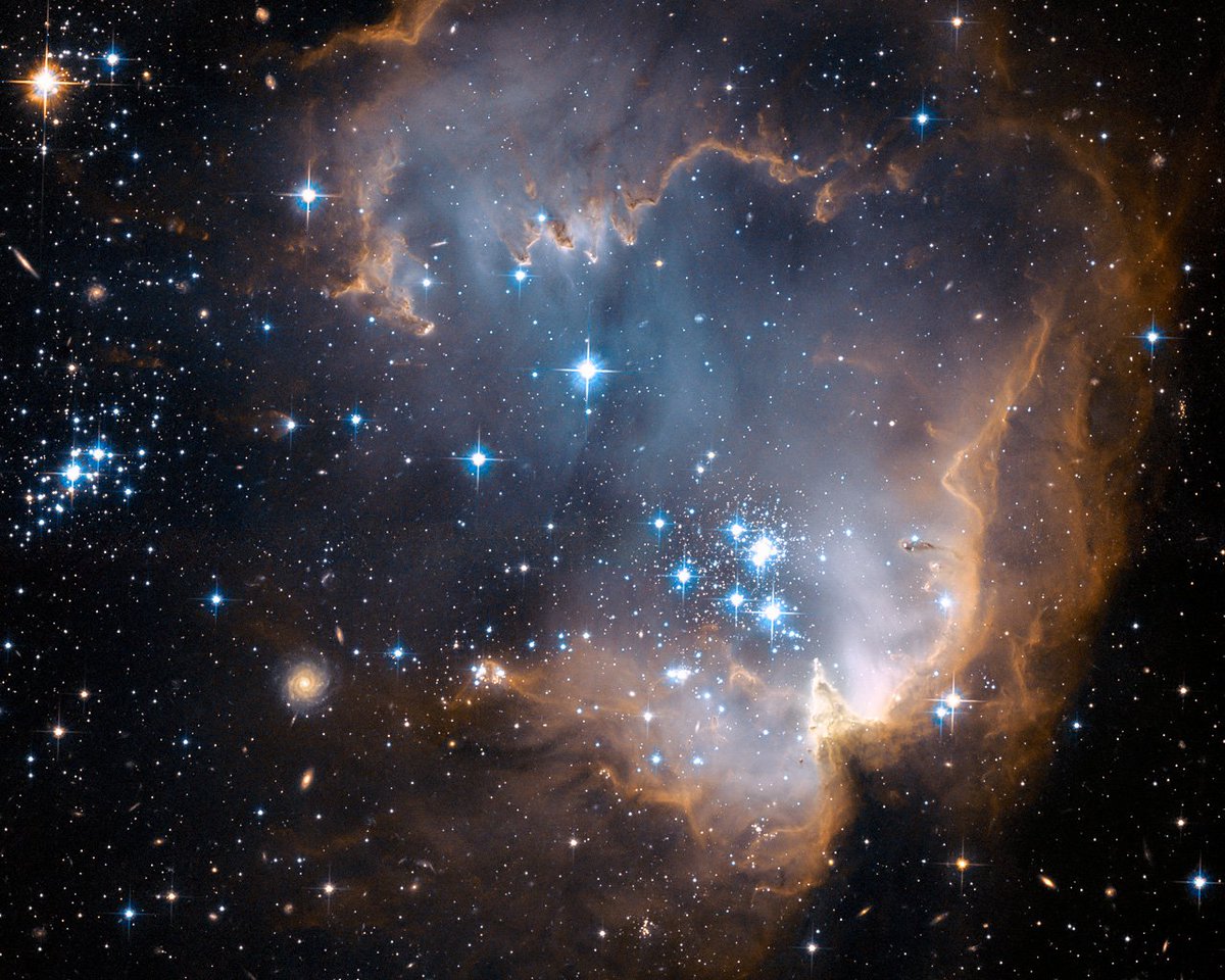 redditSpaceView's tweet image. This image depicts bright blue newly formed stars that are blowing a cavity in the centre of a fascinating star-forming region known as N90