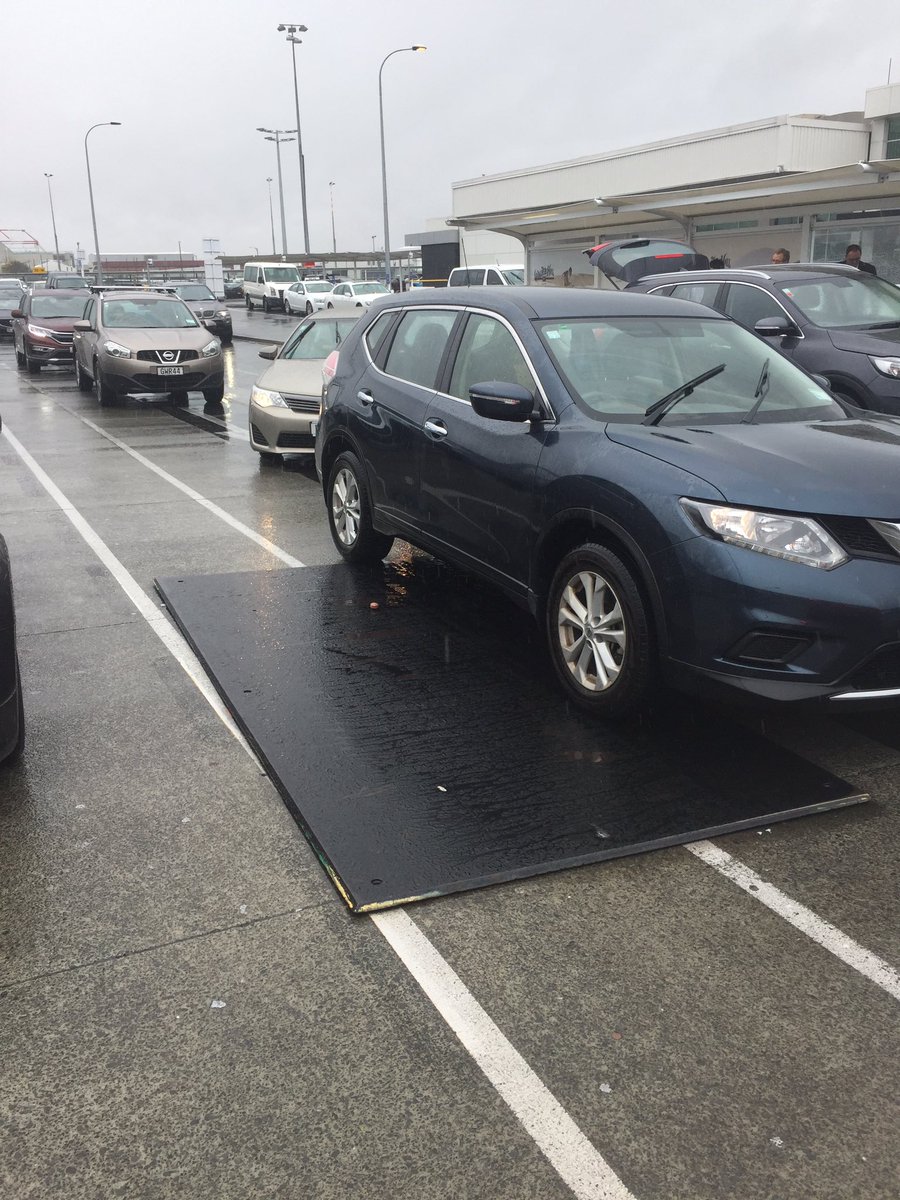 davowilson's tweet photo. @AKL_Airport just went over on rubber mat on road in front of domestic terminal. An accident waiting to happen esp in today's wet conditions https://t.co/g1URqHnfIy
