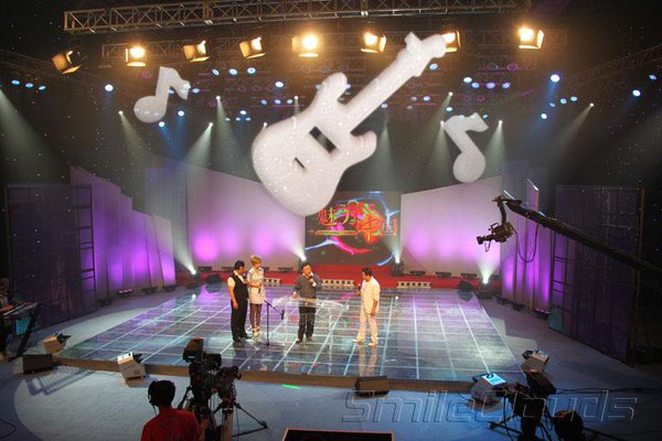 Clouds shaped as guitar floating up to "sky" of studio.