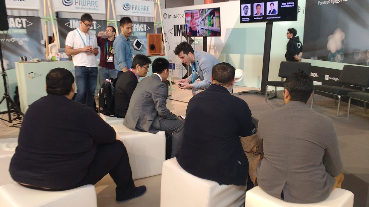 FIWARE's tweet photo. Jose Benítez @secmotic talking w/ delegates from #ChinaMobile #IoT @GSMA at #IMPACTgrowth stand about powered by #FIWARE solutions @4YFN_MWC https://t.co/PYSAhKHj7C