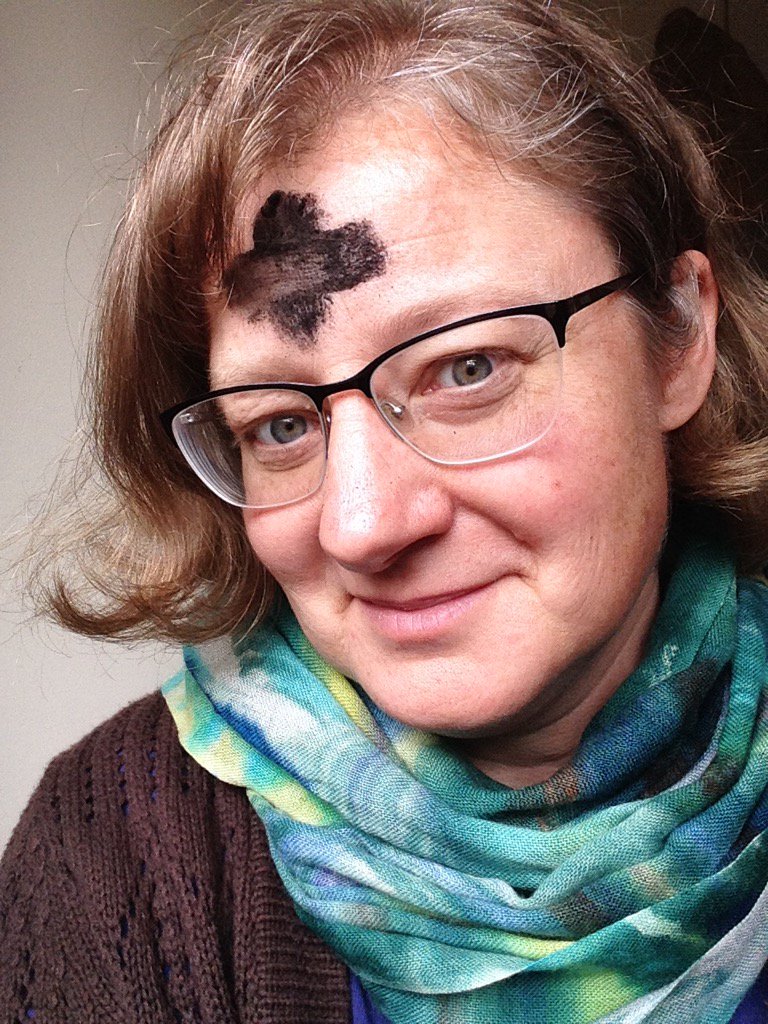 Jen with massive black ashen cross on her forehead.