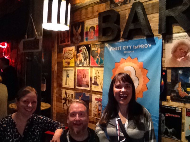 Me and 2 other improvisors in front of a sign for San Diego Improv Festival