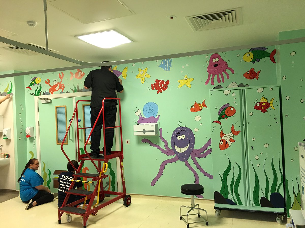 GLE lions and Tesco Community team painting pediatric recovery ward at Morriston hospital