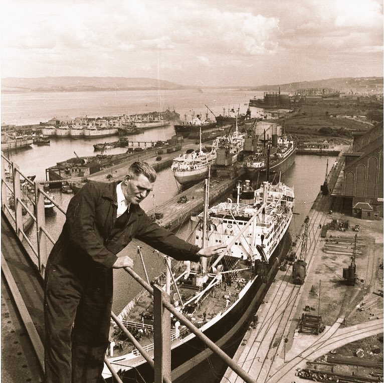 craneoftheweek's tweet photo. Neil McKechnie stands on the giant cantilever crane above Greenock docks on the River Clyde, 1954. #CranesForever ❤️ https://t.co/q8S2qIw3w4