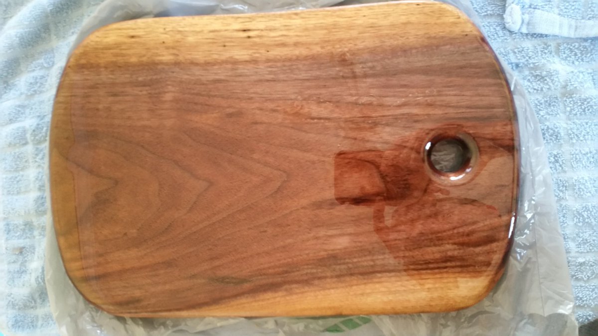 This is a live edge cutting board soaking up some oil from my stash of North Carolina black walnut!