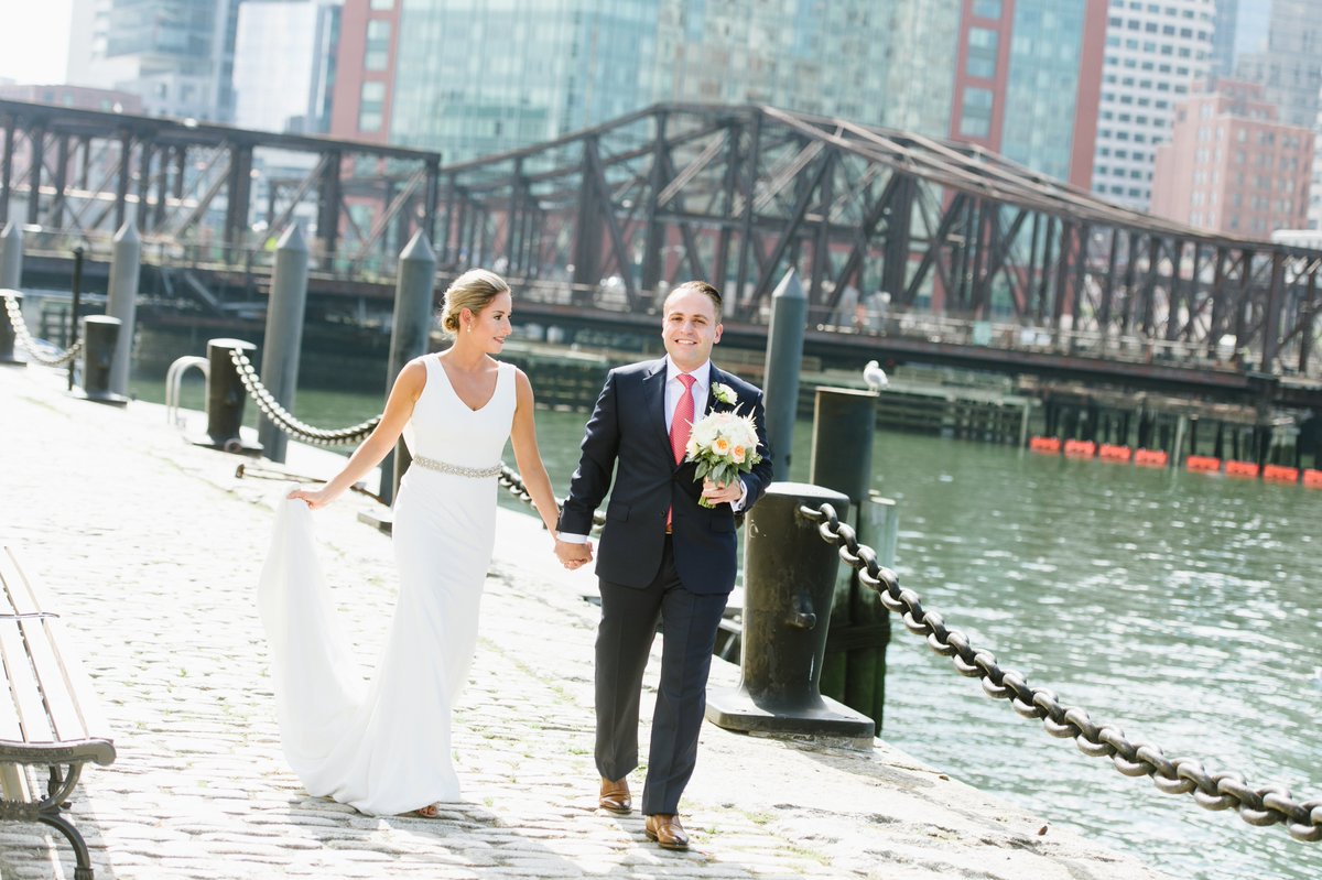 Always love when the photographer captures a shot of the Groom carrying the bouquet. Photo credit: Molly Anne Photography