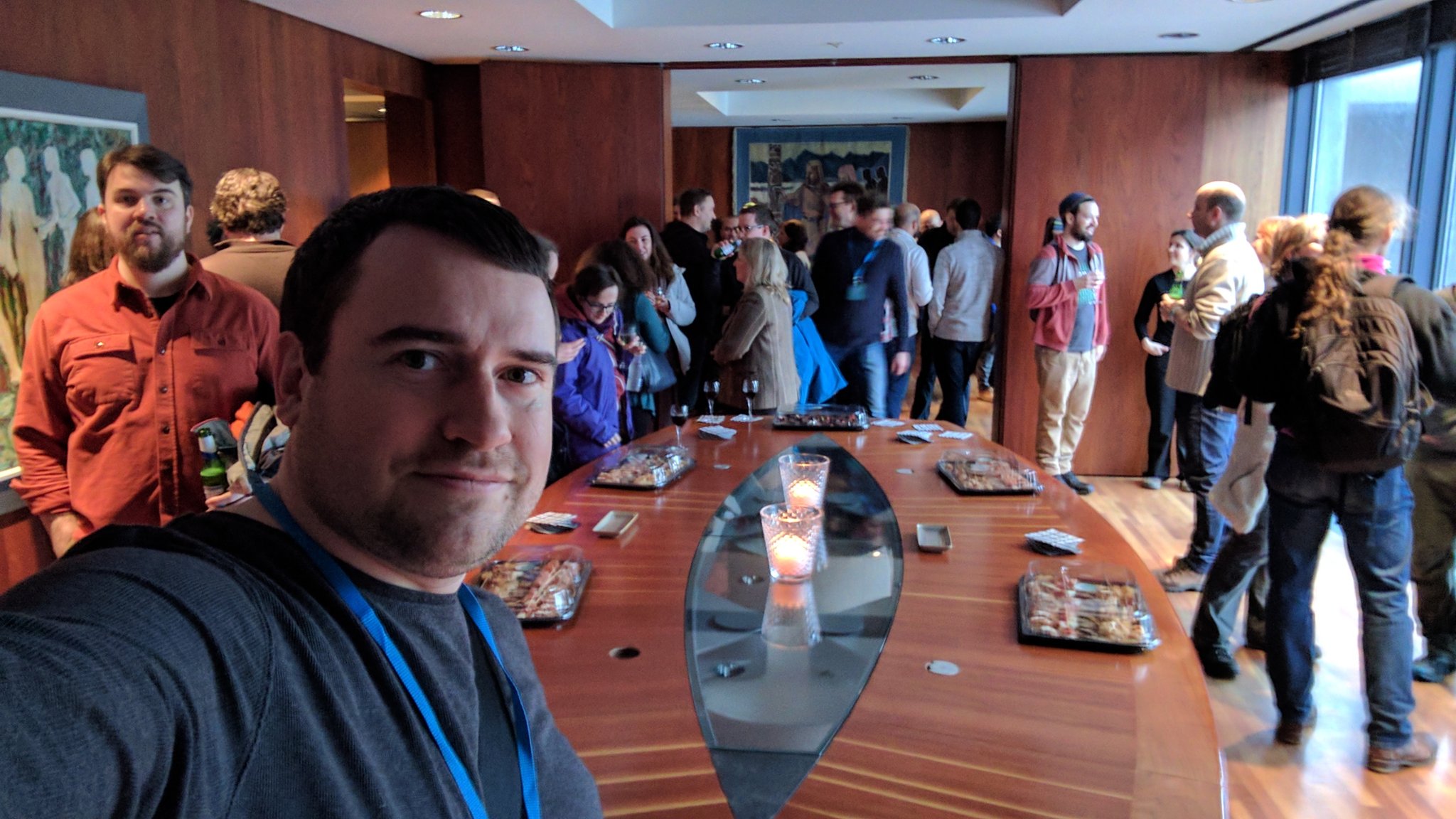 group of drupal developers around a large table, it is a selfie pic