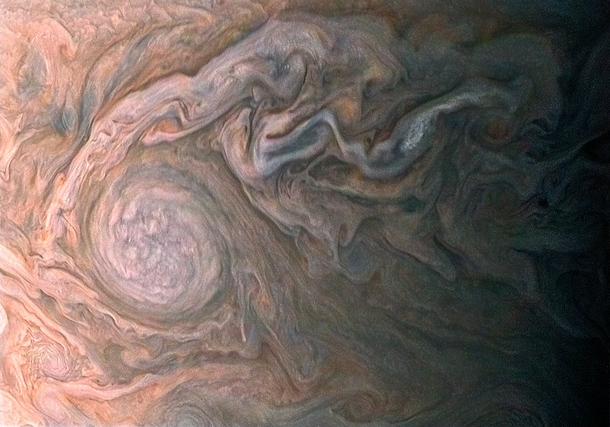 NASAJuno's tweet image. Jovian art. Streams of clouds spin off a rotating cloud system in this new #JunoCam #Jupiter image missionjuno.swri.edu/news/jovian-art #STEAM