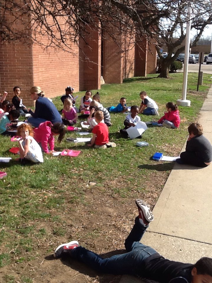 Mrs. Angle's class working on writing outside on this beautiful day.