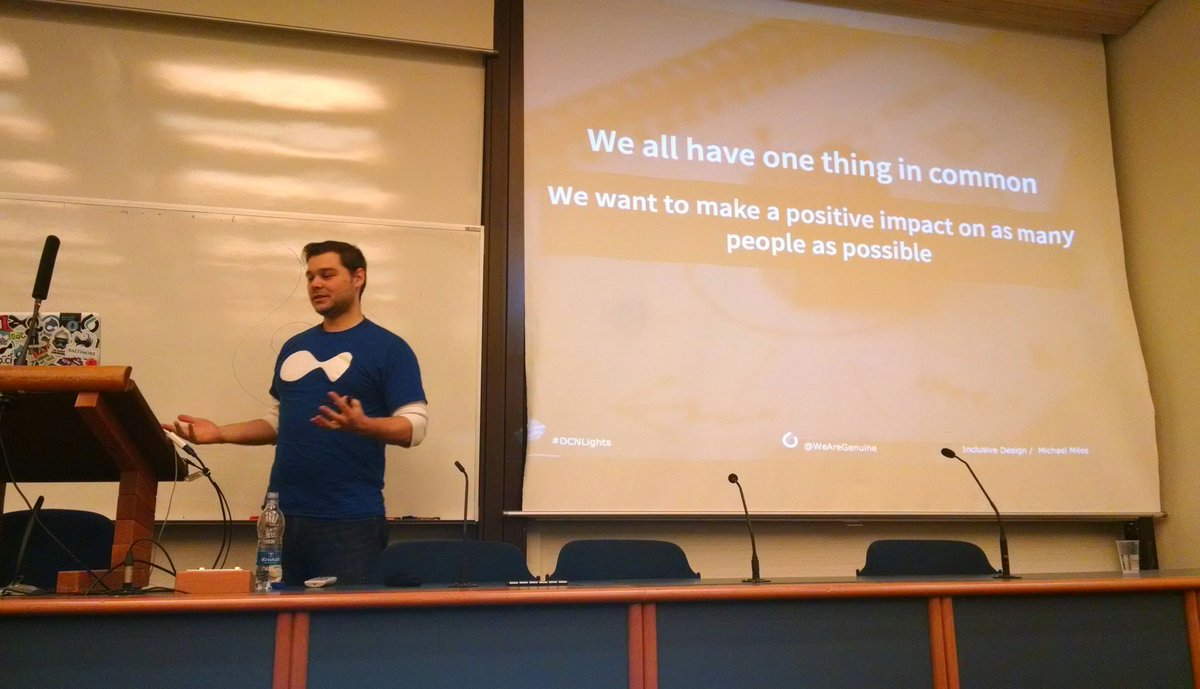Mike standing in front of a whiteboard witht he title of the talk on the screen