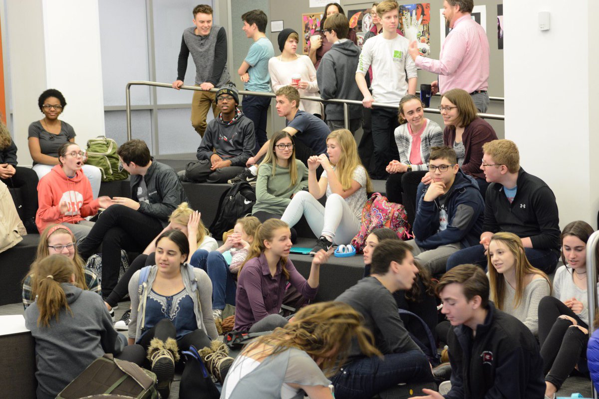 Students gather for conversation in the community room before school starts.