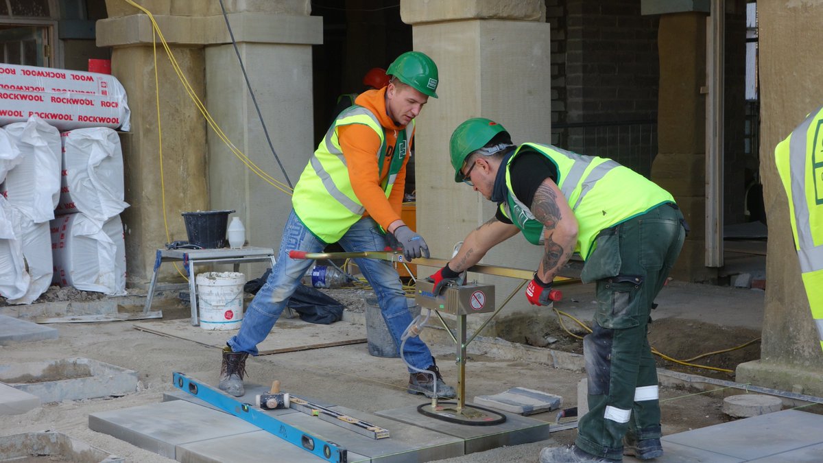Calderdale's tweet photo. Work continues on @ThePieceHall courtyard as paving stones are laid and a new entrance from the @OrangeBoxHX has been created. See pictures https://t.co/mqs4bTHJfQ