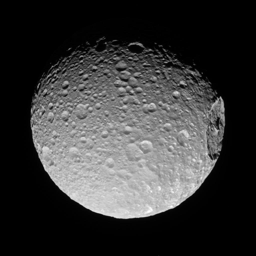 NASA's tweet photo. Saturn's moon Mimas' gigantic crater Herschel lies near its limb in this view from our @CassiniSaturn spacecraft: https://t.co/VdtOOUJC37 https://t.co/b4OL6EAyG7