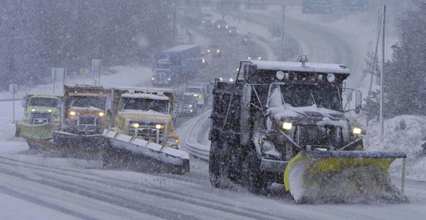 A snow plow quartet works to clear the Sagamore Bridge in Massachusetts