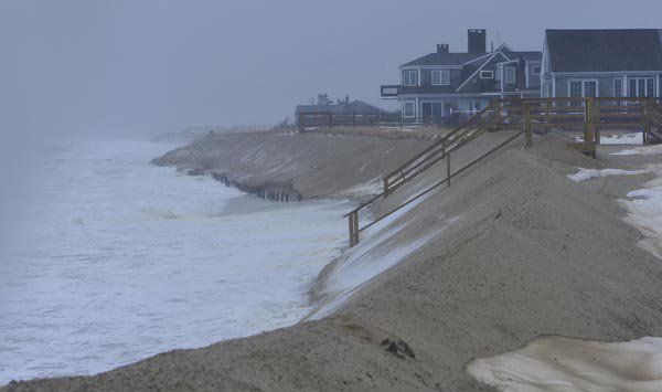 High tide bangs away at the latest sand ridge protecting Town Neck Beach homes