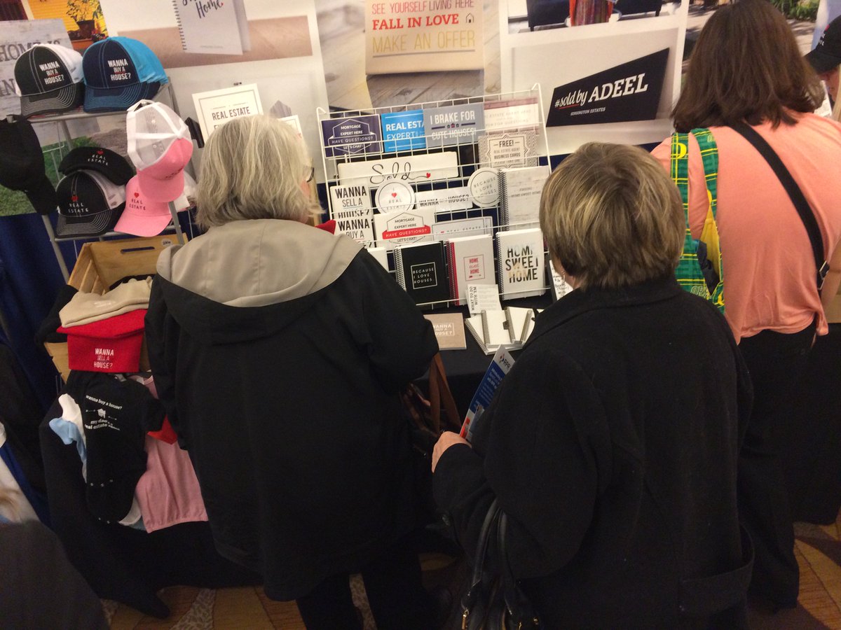 RMLSweb's tweet photo. Attendees peruse the selection of signs available at the All Things Real Estate booth. #RMLStf https://t.co/wlOsJ69ang