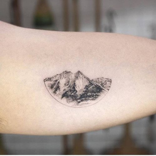 Mountain tattoo located on the ankle.