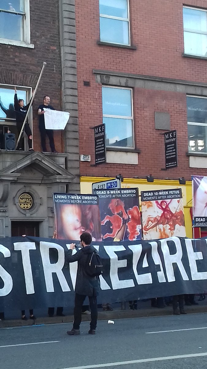 RosaSocFem's tweet photo. That white sign above says Tuam babies, something our antichoice shadows have been very quiet about #Bus4Repeal #Strike4Repeal https://t.co/sKs6J61YOH