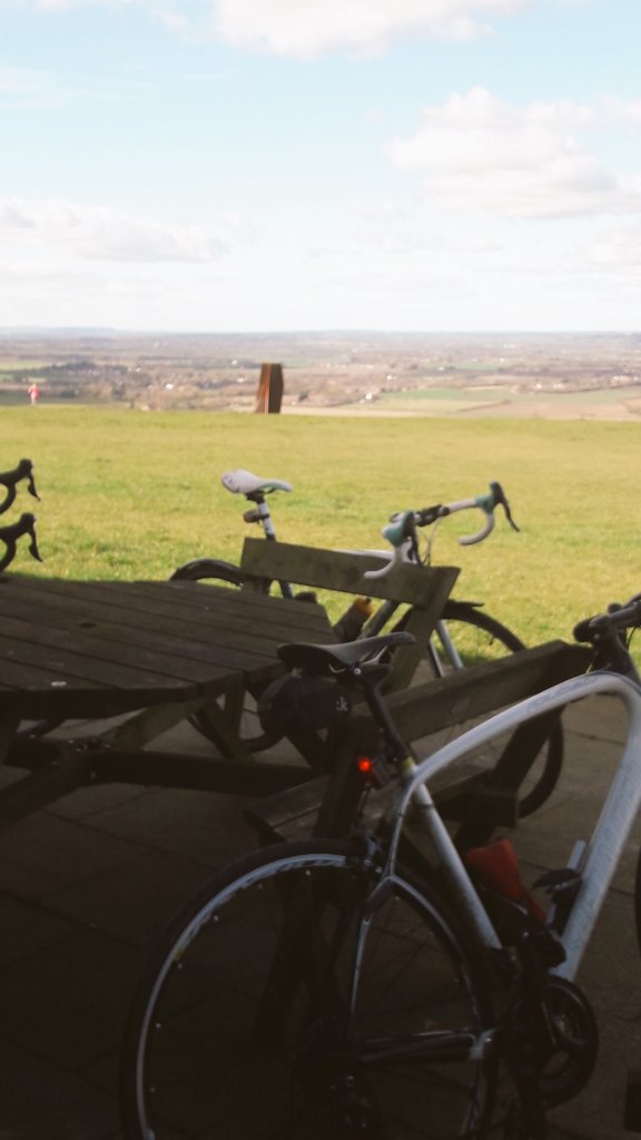 Tri50coaching's tweet photo. Now that's a bike cafe with a view. But what is that sculpture... #theSunIsOut #Tri50Cycling https://t.co/Zho09W6Qli