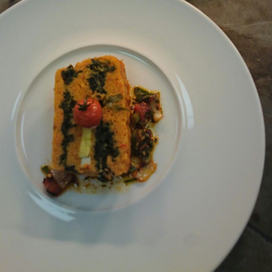 It's amazing what our chefs can do with traditional dishes. Here's #moinmoin terrine with spinach and eggs, topped with a cherry tomato.