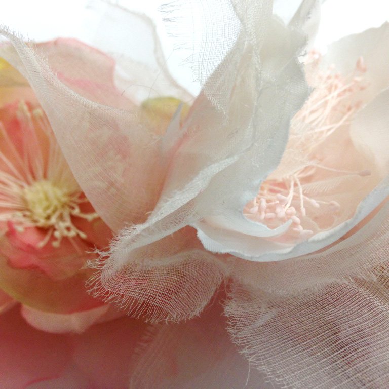 Soft, pastel colours from these pink and orange flower corsages. The light texture from the petals add a feminine &amp; fresh feel.