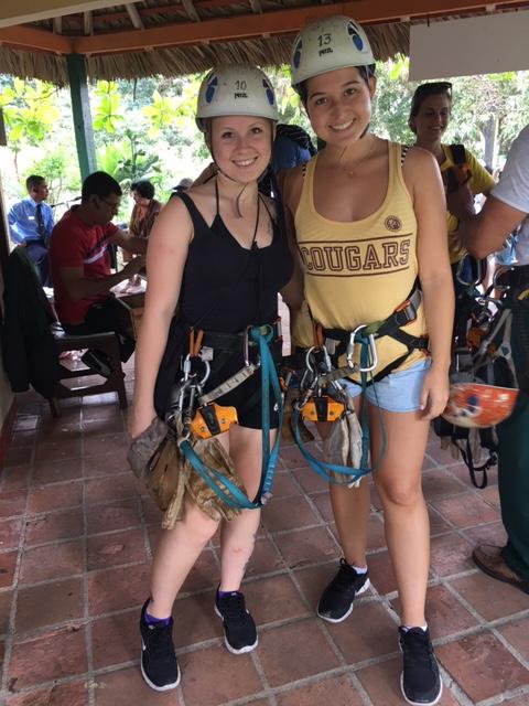 Students Shea Held (left) and Maggie McClarin rigged to zipline at Las Terrazas in Cuba. #CofCinCuba