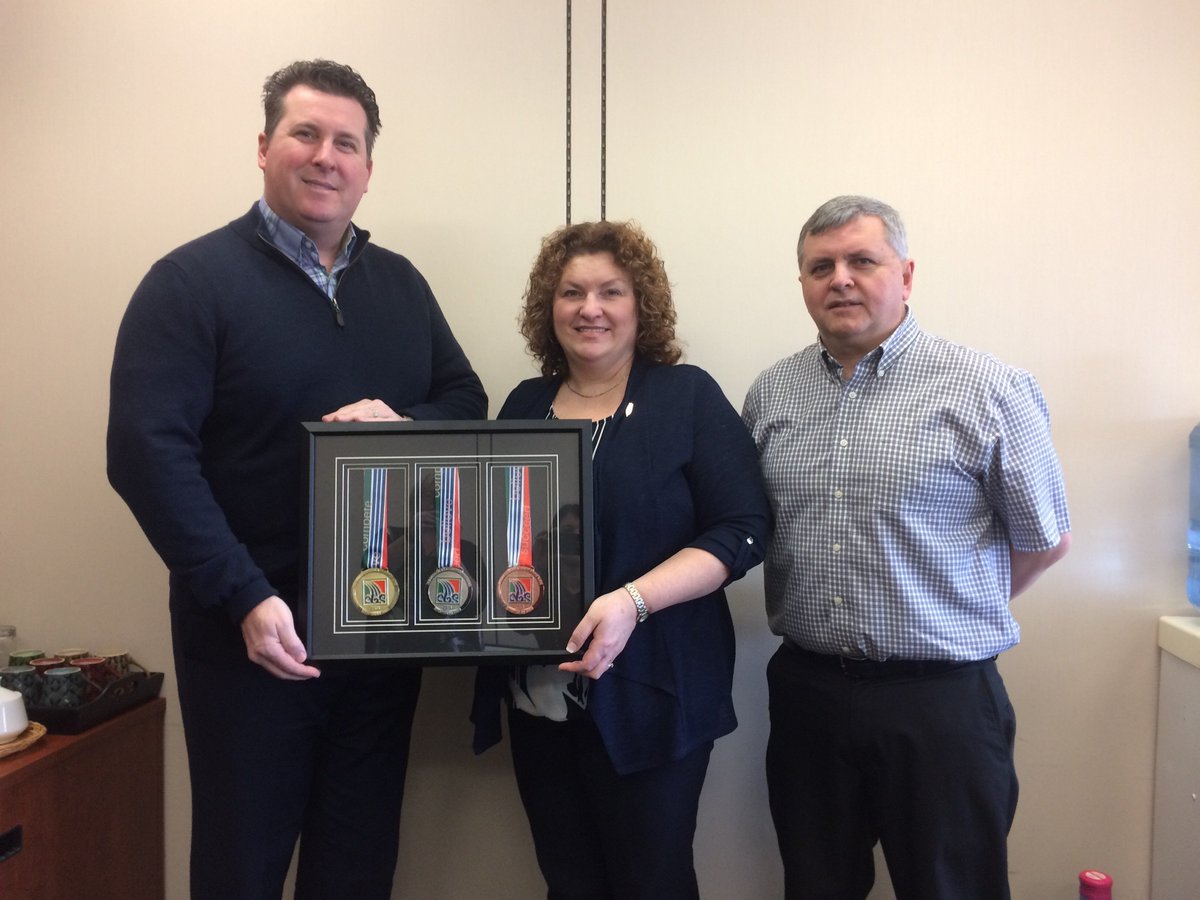 1/2 Eric Schibler, Chairperson (l) and Ellis Coles, Games Manager (r) for the NL 2016 NL Games in CBS make presentation to Minister.