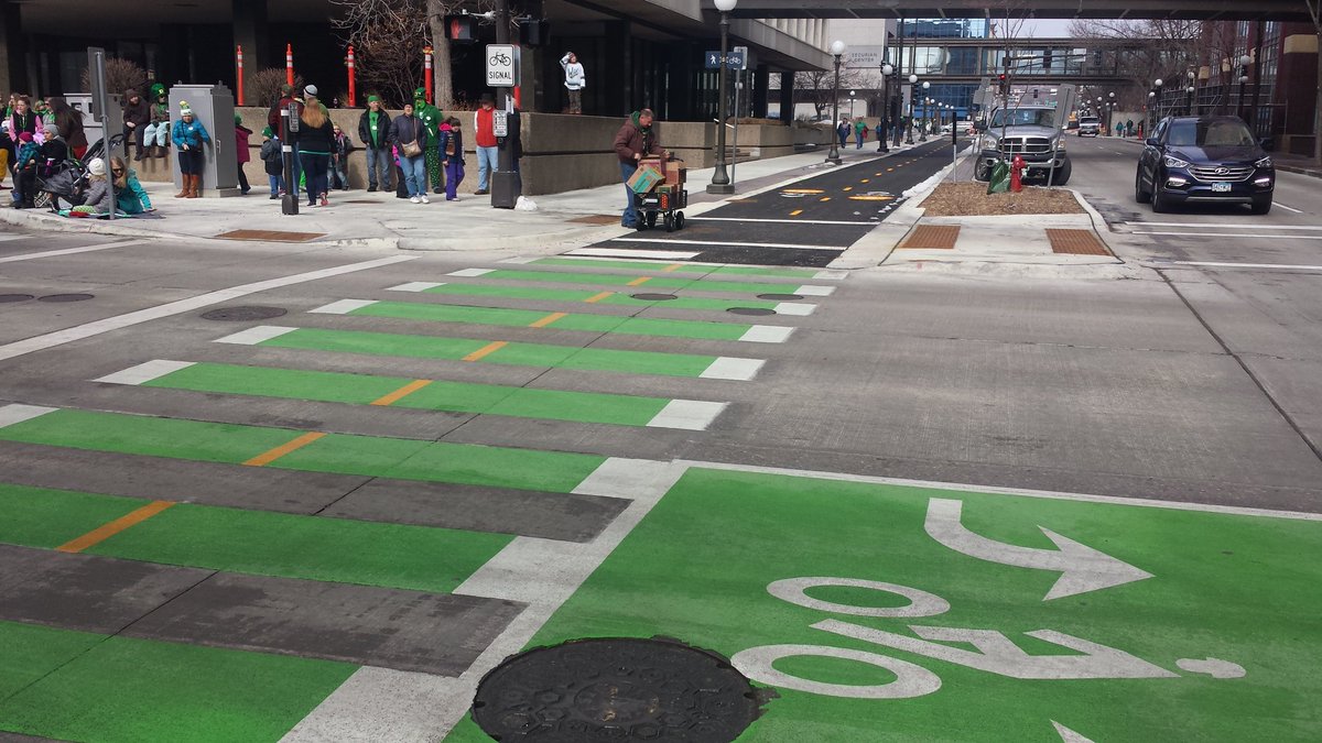 PioneerEndicott's tweet photo. They painted the bike crossings green! #StPatricksDay #lowertown https://t.co/EhO273eZhJ