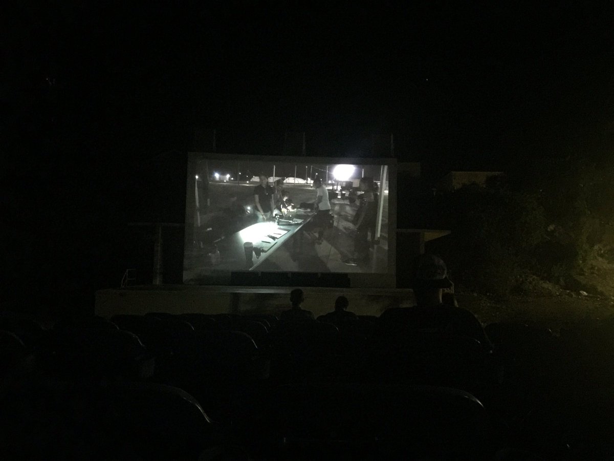 Watching Logan at one of the outdoor Lyceums down here. Nice ocean breeze to keep the bugs away.