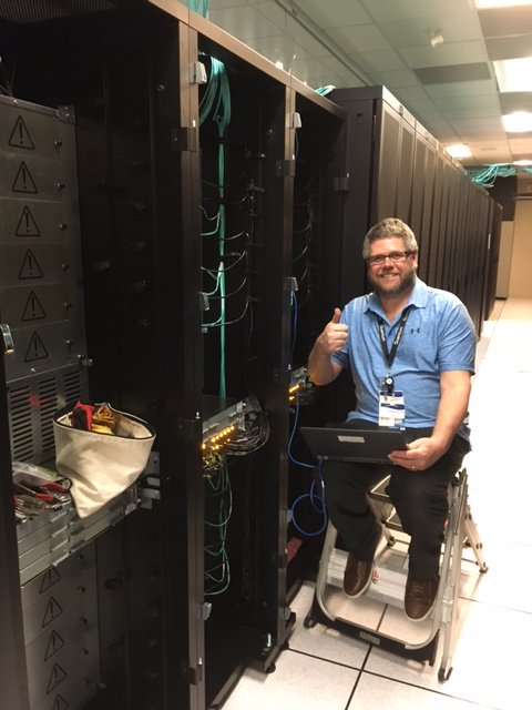 QuantumCorp's tweet photo. Jerry loading software on a fresh installment! What a beautiful i6K 5 module library! #storage https://t.co/0qwFEBuOsu