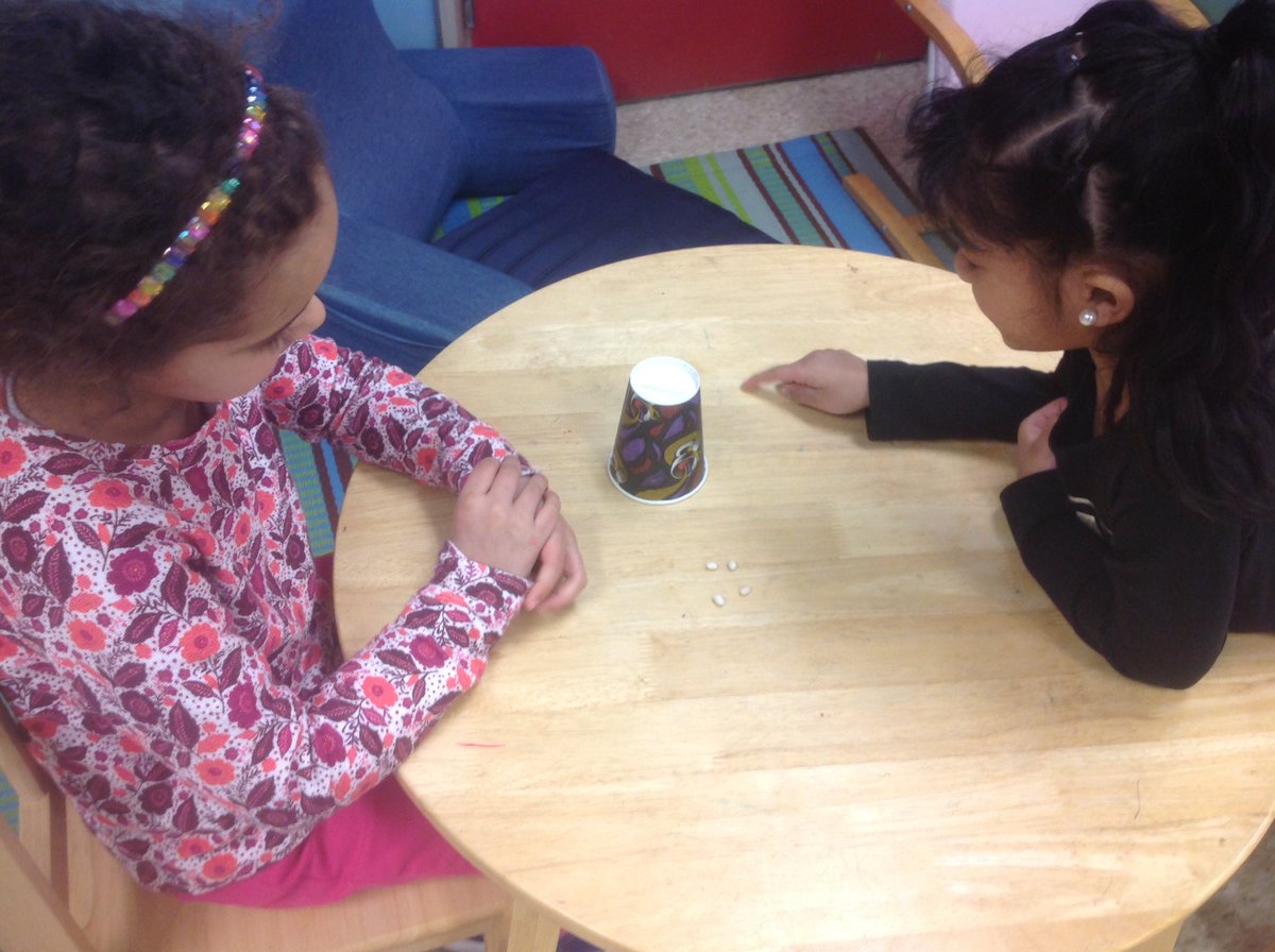 Start with 10. How many beans are under the cup?  How do you know? #buildingunderstanding #mathtalk