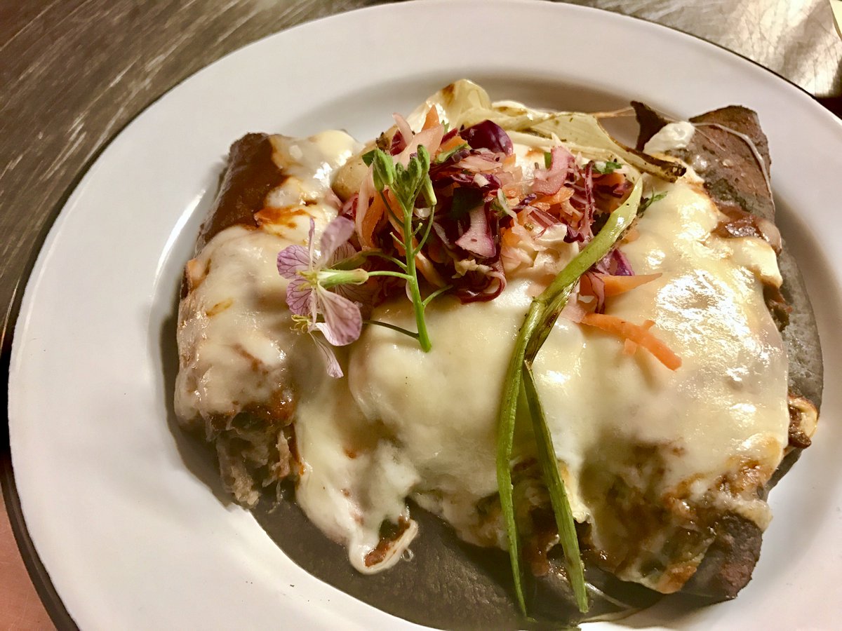 Wagyu Barbacoa Enchiladas with Quesillo, Black Bean Purée and Charred Spring Onion