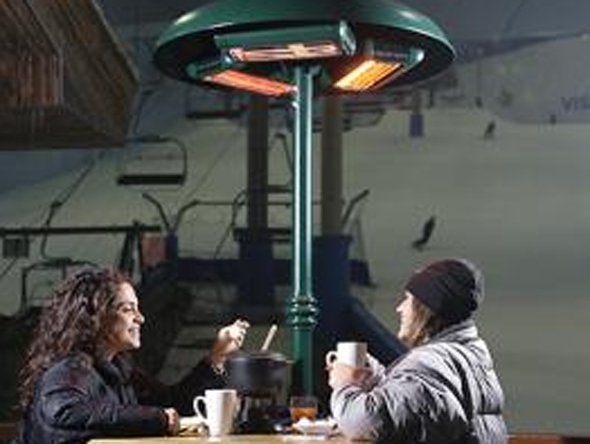 Here's a photo of people eating fondue under heat lamps in an indoor ski resort, in the blisteringly hot UAE. No sense of irony.