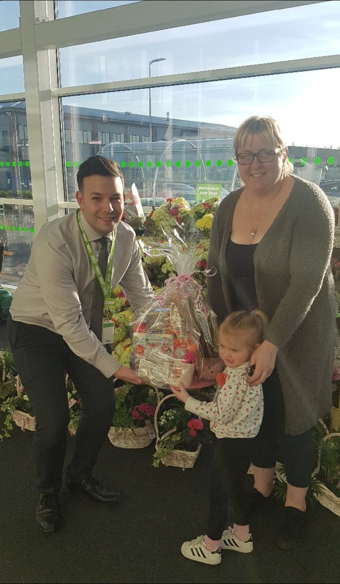 Store manager Dan presenting claire with her Mother's day hamper she won in our instore Tickled pink Mothers's day raffle.