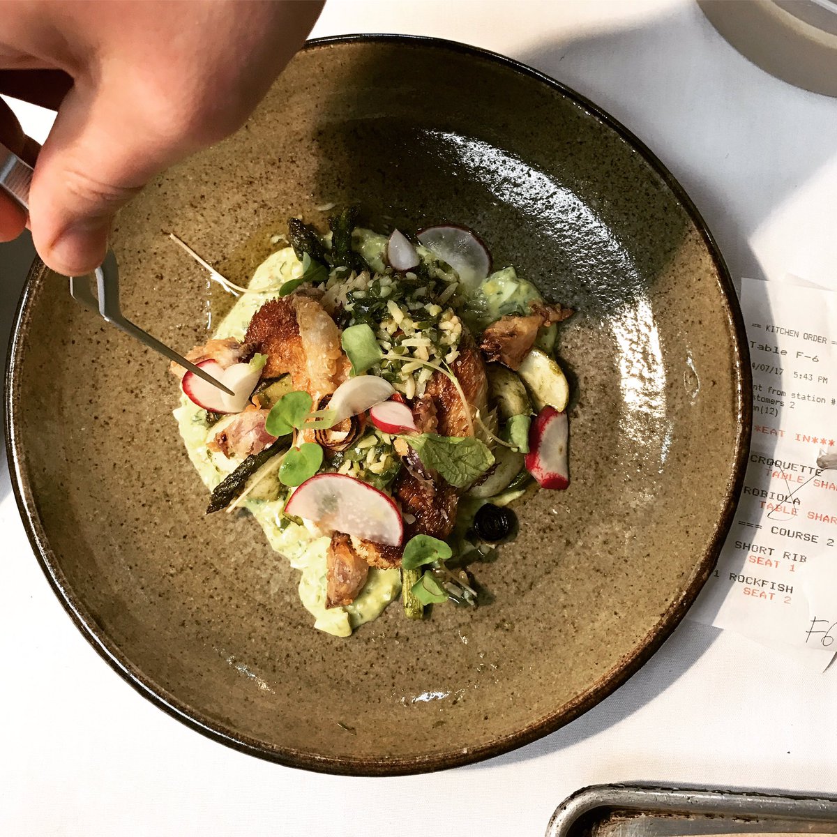 [ATTENTION TO DETAIL] Chef May puts the finishing touch on the new lion's mane mushrooms, asparagus, gribiche sauce on the vegetarian menu.