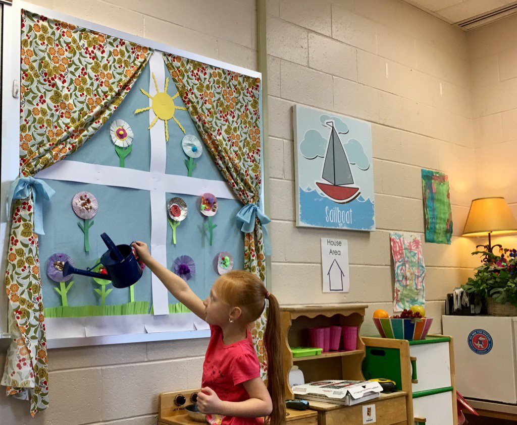 Watering the flowers outside our kitchen window.