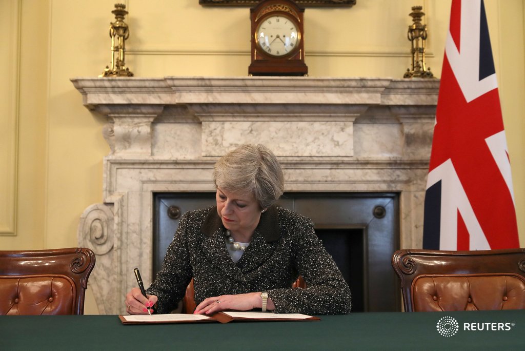 Reuters's tweet photo. .@Reuters photo shows British PM May signing #Brexit letter to EU: https://t.co/3N7SB25Qgx https://t.co/cc3hETPp42