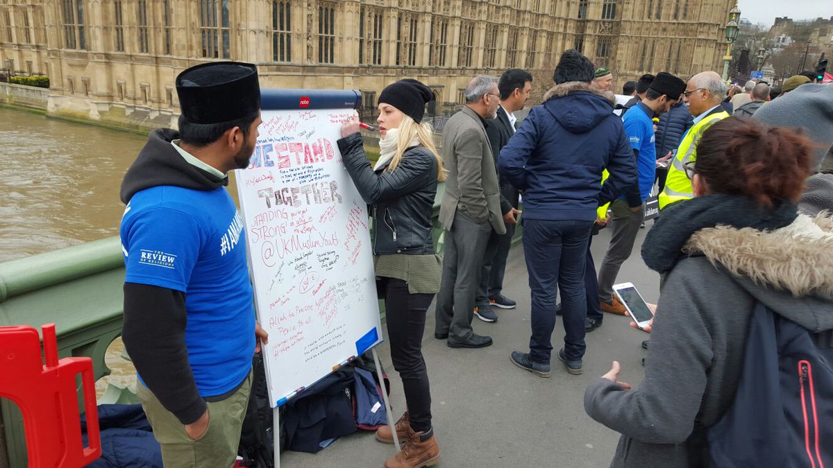 SafwanChoudhry's tweet photo. Cladded with "Love For All Hatred For None" banners, hundreds of Ahmadi Muslims gathered on #Westminster Bridge London in defiance of hate. https://t.co/TYjPsnV6GI