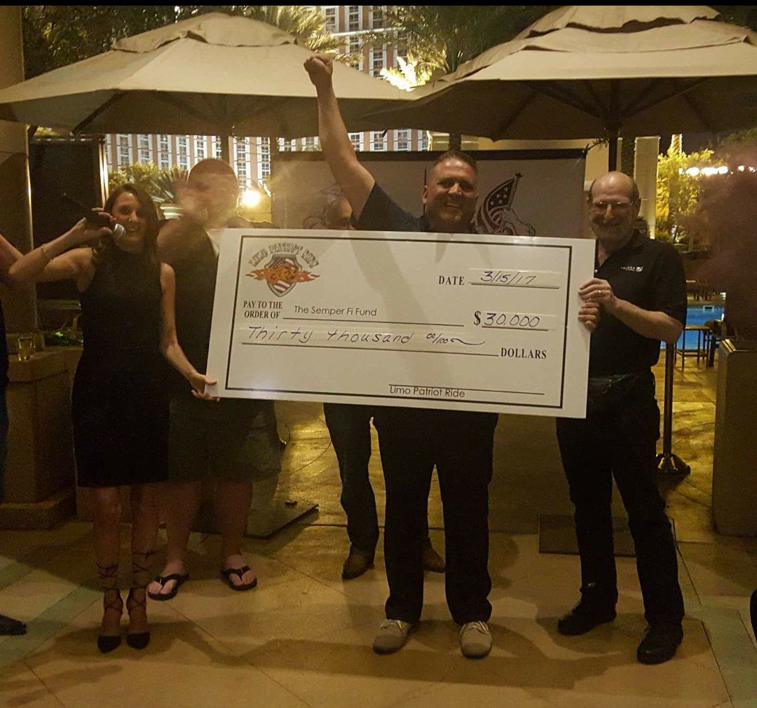 MomentumDrives's tweet photo. Momentum Drives presenting a check for $30k to @SemperFiFund on behalf of Driving For Change at the Limo Patriot Ride #givingback #donate https://t.co/10li0MJCAo