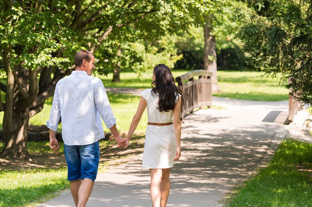 Happy Lesbian Couple Walking Along A Cornfield