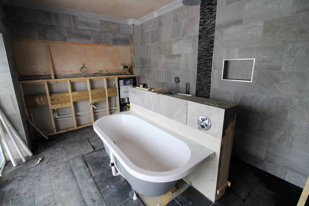 designandbuild's tweet photo. Tiling time at the #swimmingpool ! The bath centered in the room with views over the rolling countryside...heaven! #photobuilddiary https://t.co/PSYXvDnWPY
