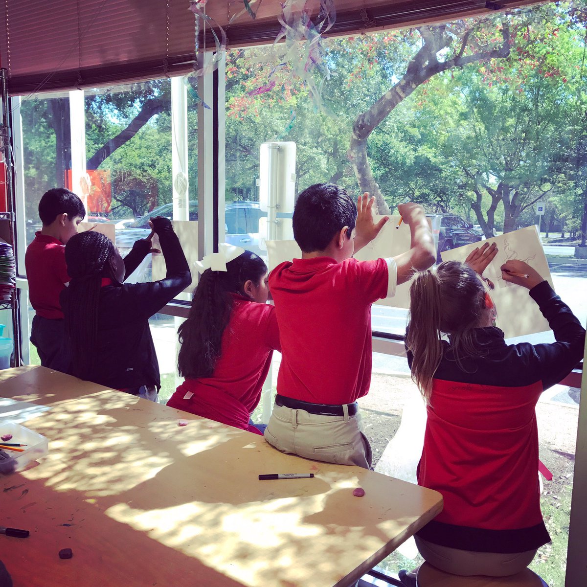 5th grade Art students are using windows as light boxes as they work on their radial symmetry designs! #nationalyouthartmonth
