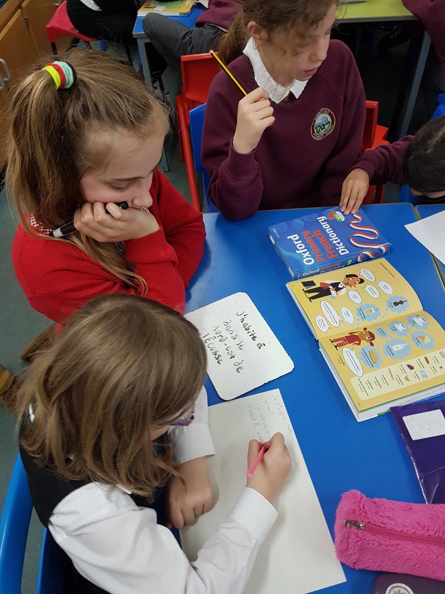 DunnottarSchool's tweet photo. P7 helping P3 to write letters to our 'twin school' in Nebouzat. #collaborativelearning #1+2 #literacyinlanguages #primarylanguagelearning https://t.co/iwXtQE6sW9