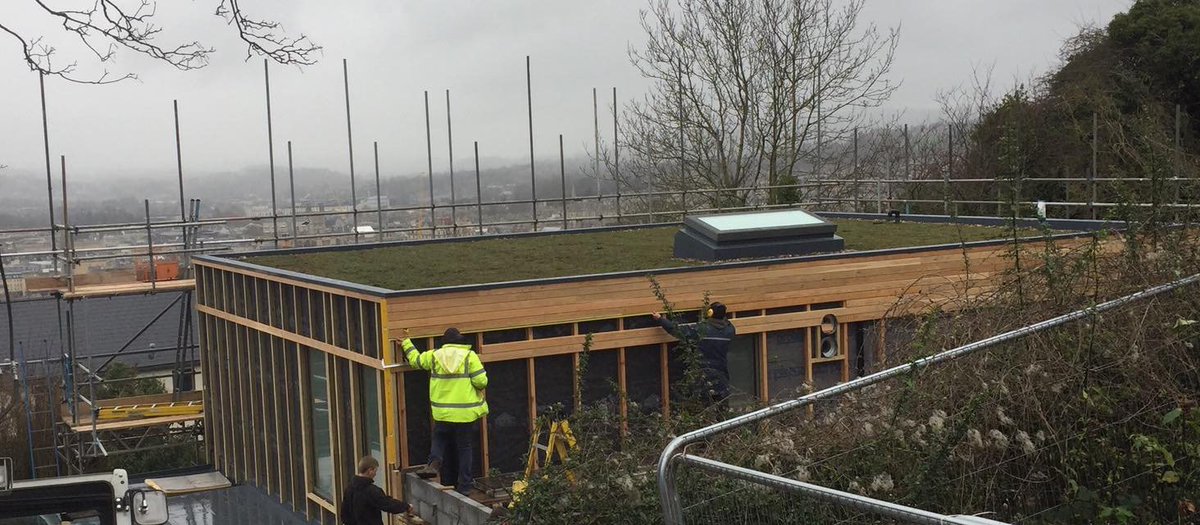 claudeandmaud's tweet photo. House build week 52: the end might actually be in sight, tiling, plastering, cladding, topsoil all going on this week...#sedumroof https://t.co/B7HBRDbOih